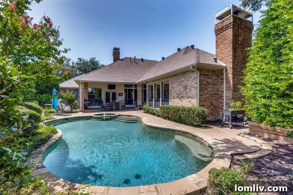 Custom pool and covered patio in a beautifully landscaped backyard