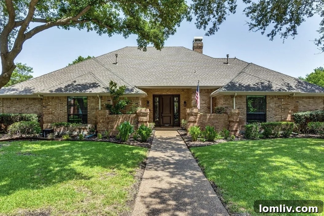 Front facade of the West Plano home with vibrant greenery