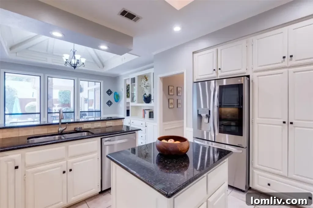 Gourmet kitchen with updated features and neutral coffered ceiling
