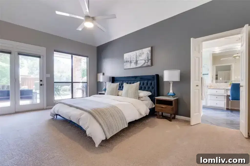 Luxurious primary bedroom with high ceilings and French doors