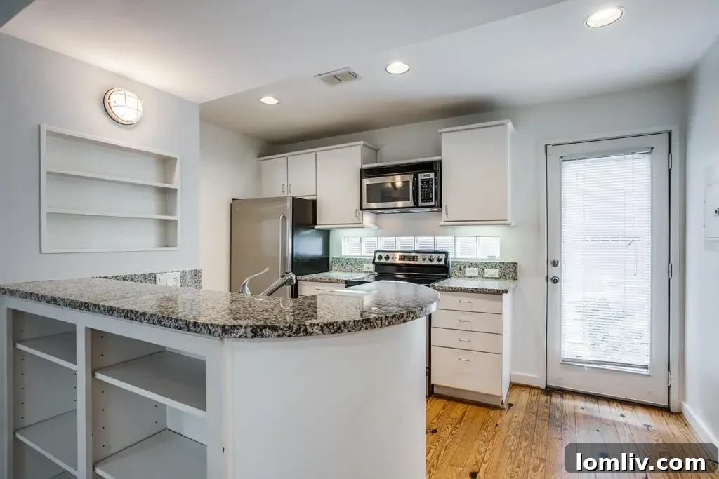 Modern kitchen with stainless steel appliances and granite countertops