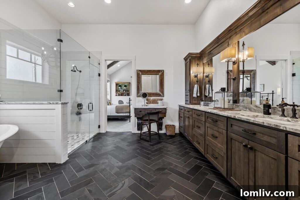 Gorgeous primary ensuite bathroom with clawfoot tub and herringbone floors