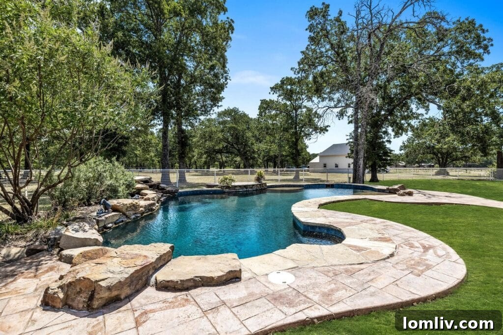 Custom designed pond pool with hand-selected rocks at Royce City ranch