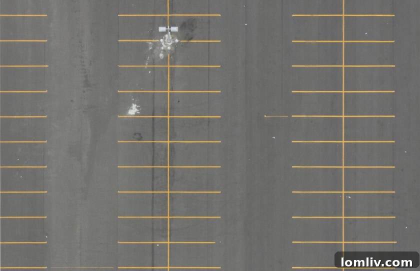 An aerial view of a Dallas street with parked cars and buildings, illustrating urban parking challenges.