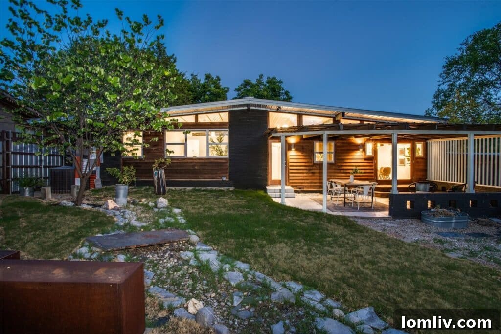 Spacious backyard with firepit area and river rock landscape feature