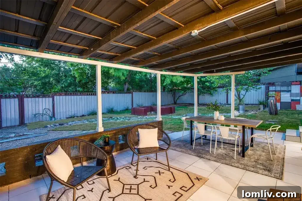 Covered patio overlooking the modern landscaped backyard