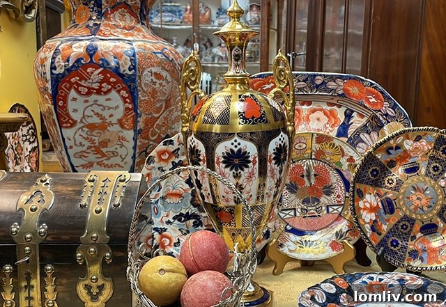 Dallas psychiatrist Joel Holiner smiling amidst his antique collection at M.D. Antiques