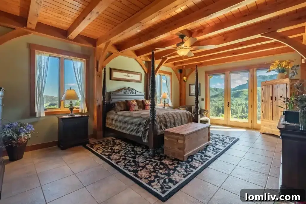 Elegant primary bedroom with large windows, offering endless views.