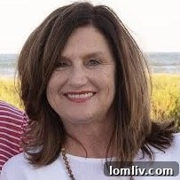 Valarie Kerby, a realtor, smiling brightly in a professional setting, exuding warmth and approachability.