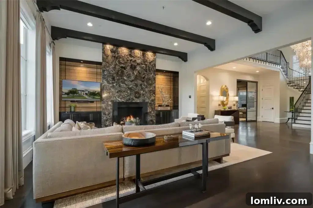 Elegant wood-beamed study with modern furnishings, designer wallpaper, and large windows.