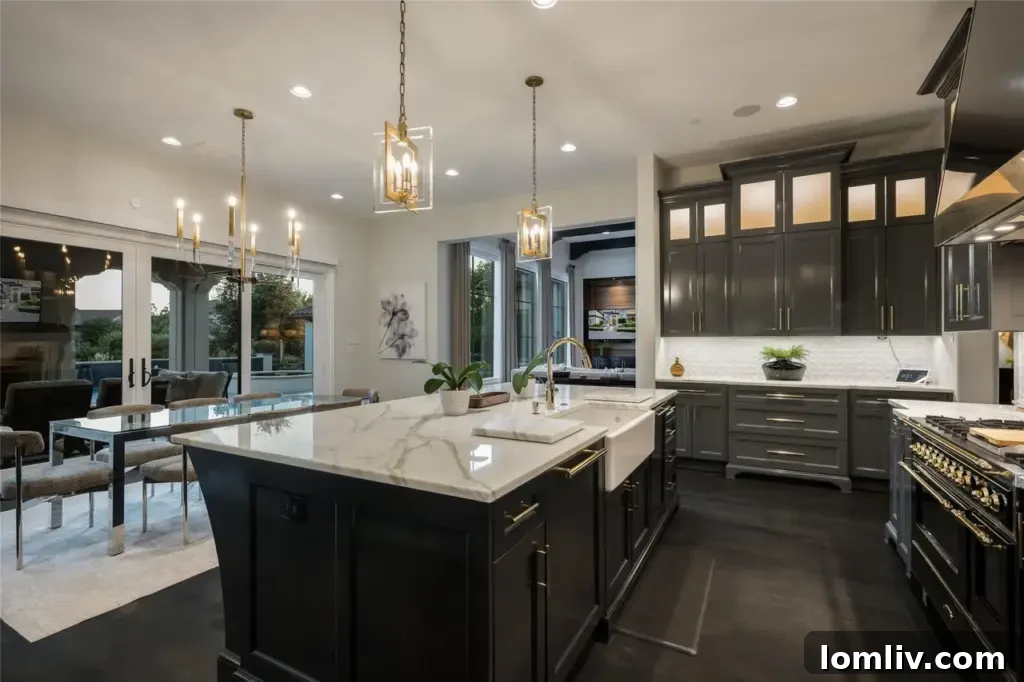 Modern gourmet kitchen with high ceilings, marble countertops, top-tier appliances, and a designer chandelier.