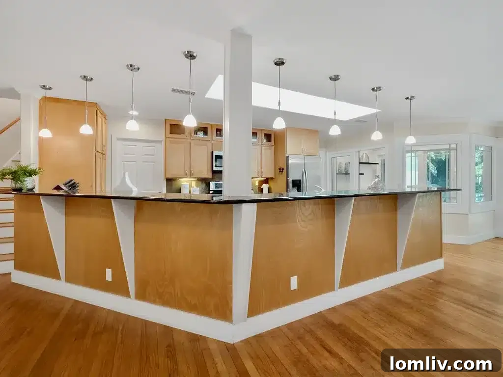 Bright and spacious kitchen featuring granite countertops, stainless steel appliances, and ample prep space for cooking.