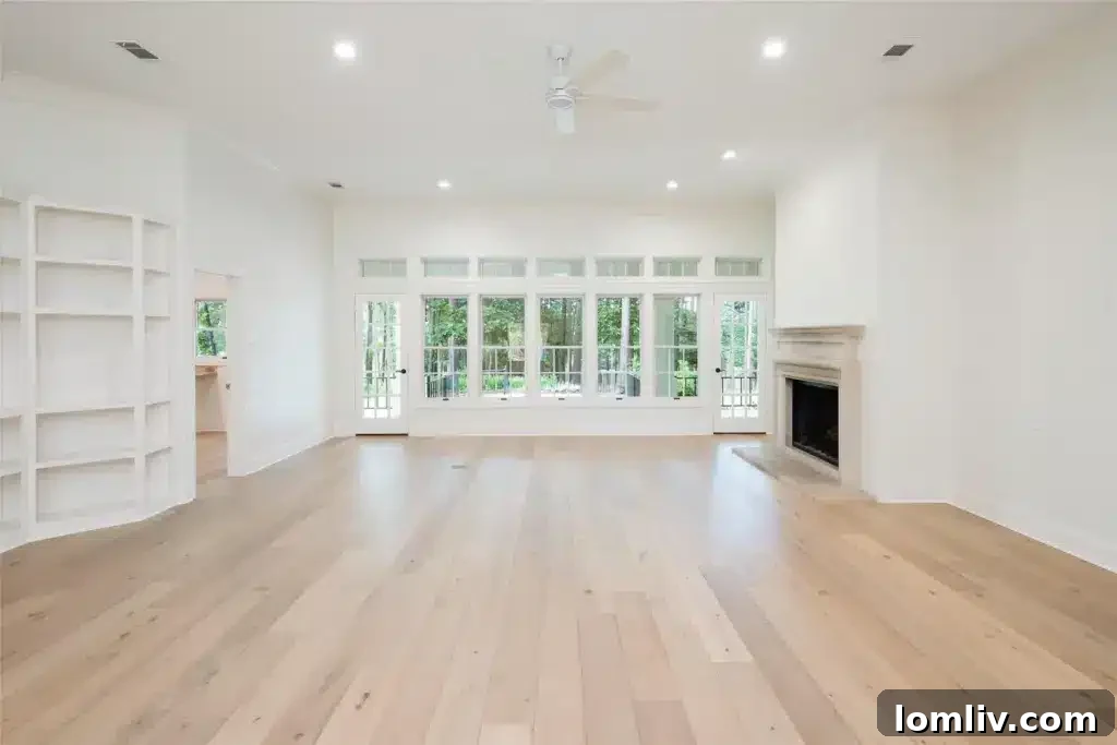 Spacious main living area with a wall of custom bookcases opening to an updated kitchen, Ben Wheeler home