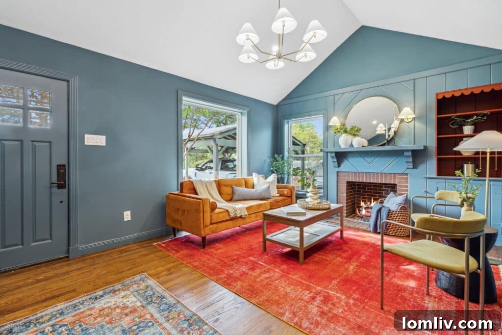 The sophisticated dining room of the Oak Cliff house, featuring a hidden bookcase entrance, muted mossy green walls, and striking orange velvet chairs, highlighting exquisite millwork.