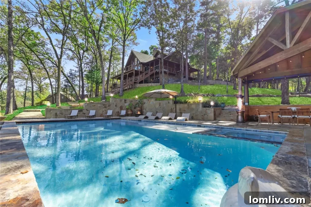 Sparkling swimming pool and spa area with stunning panoramic lake views, designed for ultimate relaxation and sophisticated entertainment.