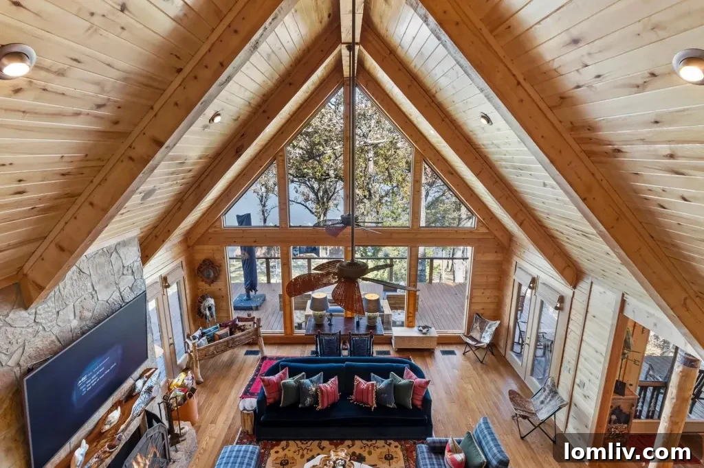 Interior view of Frogs Lakehouse's grand living area with rustic wooden beams, natural log walls, and elegant designer chandelier, offering a lodge-like ambiance.