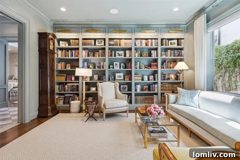 Bright and airy study with Farrow & Ball's Light Blue walls, showcasing custom built-ins and a classic desk, ideal for creative work or relaxation.