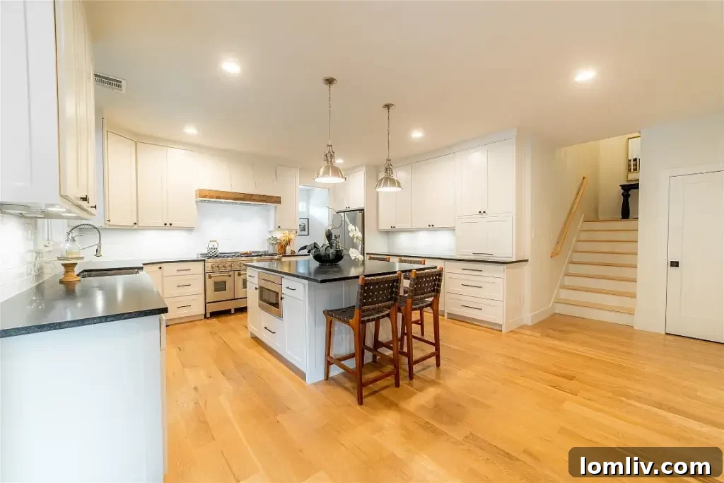 Gourmet kitchen featuring high-end appliances, a large island, custom cabinetry, and stylish lighting, designed for culinary excellence.