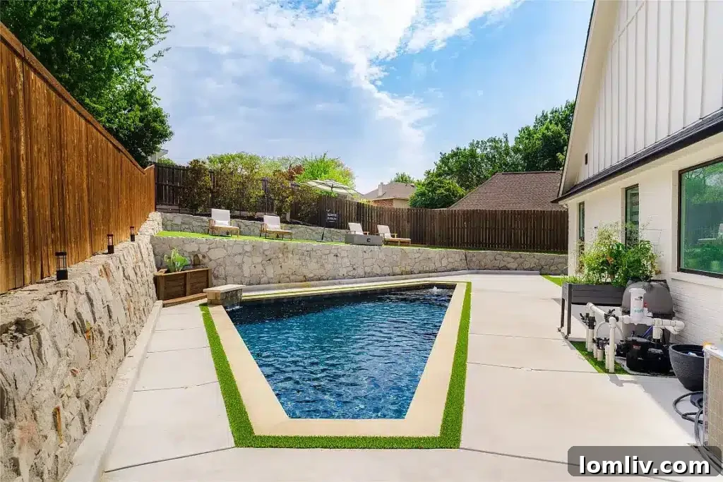 Sparkling swimming pool with an elegant terrace, perfect for relaxation and hosting large gatherings.