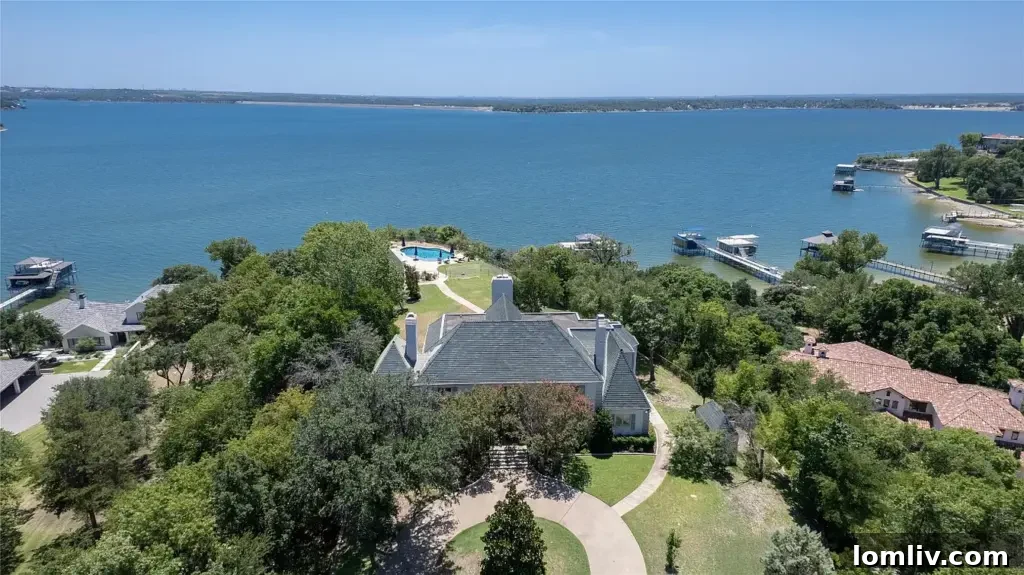 Charming stone pathway leading through manicured gardens to the entrance of the enigmatic lakefront estate.