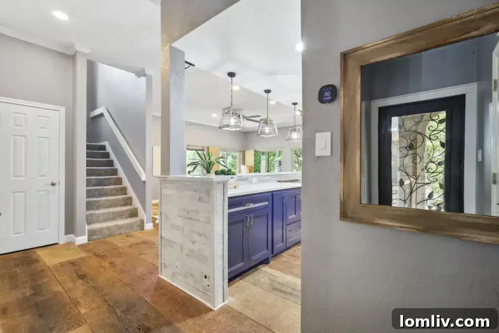 Bright and airy living room with a modern fireplace and ample natural light, showing stylish interior design at 7900 Bal Harbour Court.