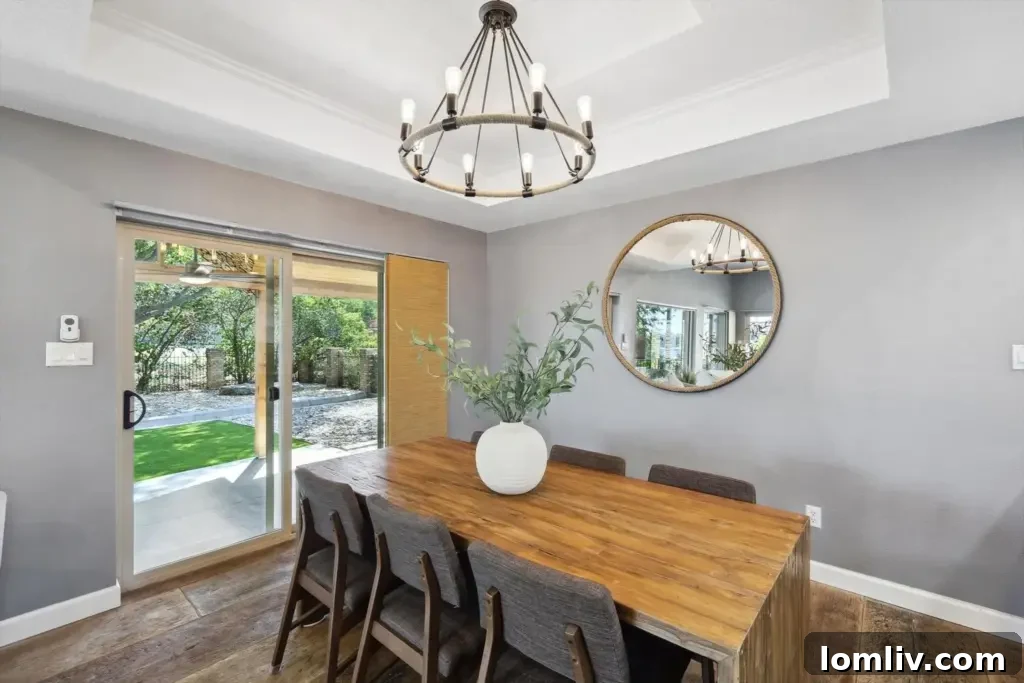 Elegant dining area with lake views and direct access to outdoor living spaces, perfect for family gatherings.