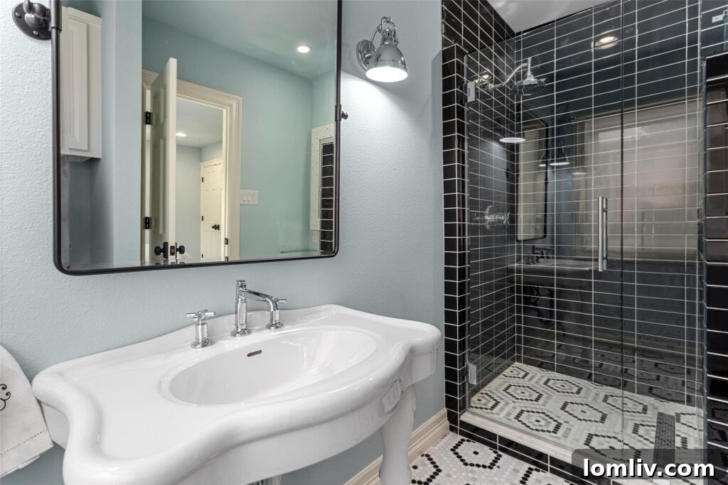Rare Midcentury Gem in Rivercrest First Time Offered 12 Luxurious guest bathroom with pale aqua walls and vintage-look console sink