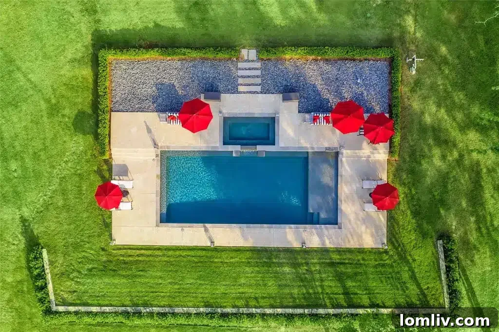 Expansive outdoor entertaining space with multiple seating areas and a stunning lake view