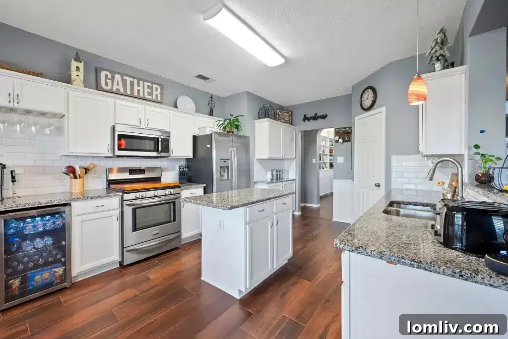 Modern kitchen with a large island, stainless steel appliances, and a coffee bar, perfect for daily use and hosting.