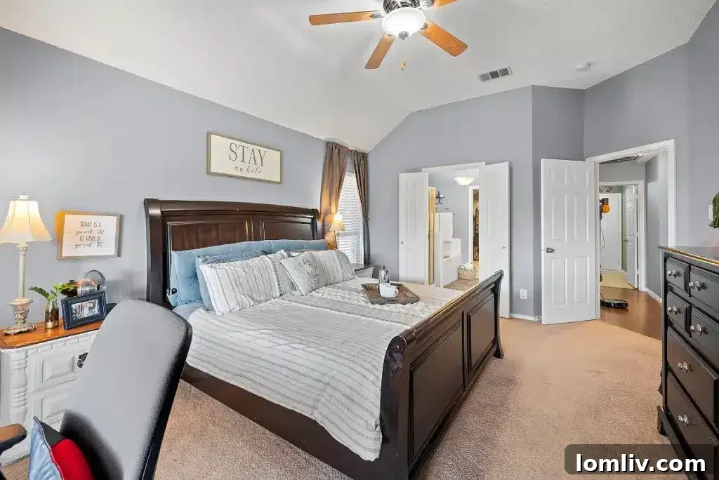 Spa-like primary bathroom with dual sinks, a large soaking tub, and a separate shower.
