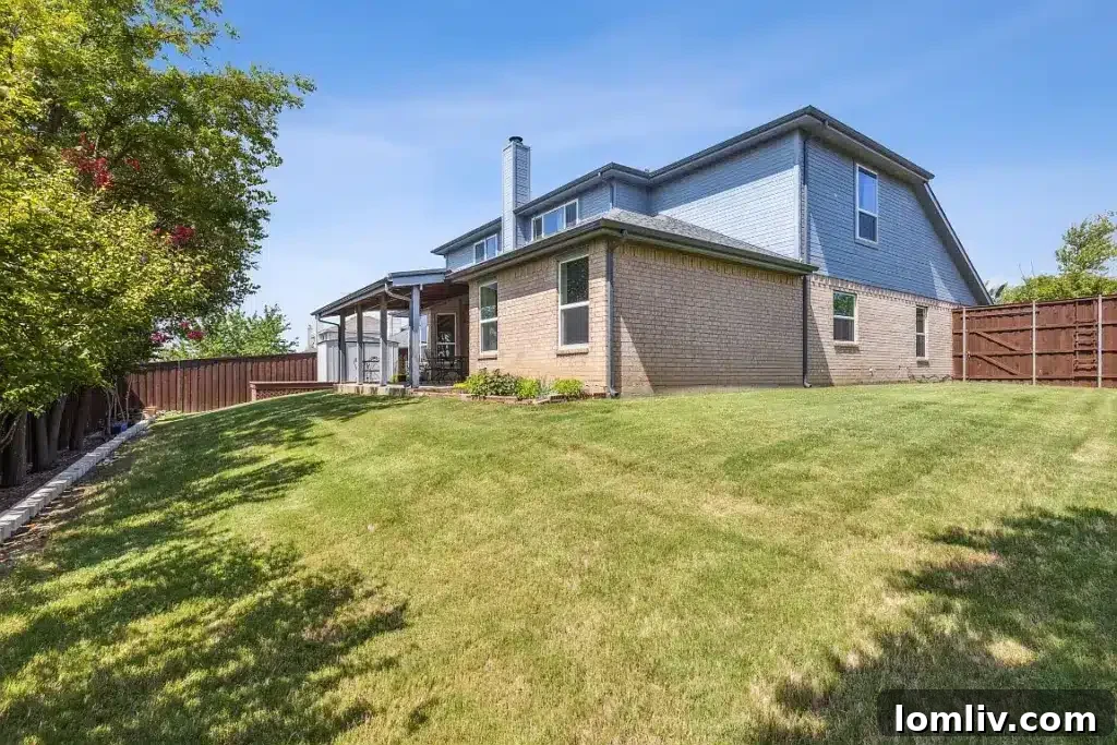 Well-maintained backyard with green lawn space, offering a peaceful area for outdoor activities.