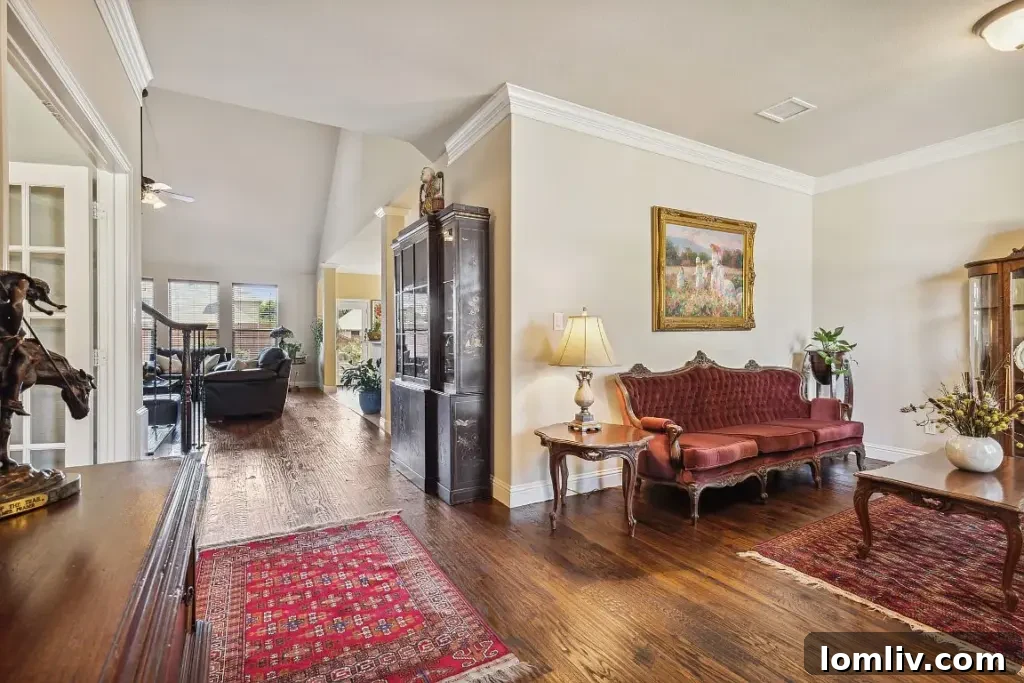 Elegant living room interior of 5728 Magnolia Estates Court, showcasing an open concept, abundant natural light, and sophisticated decor.