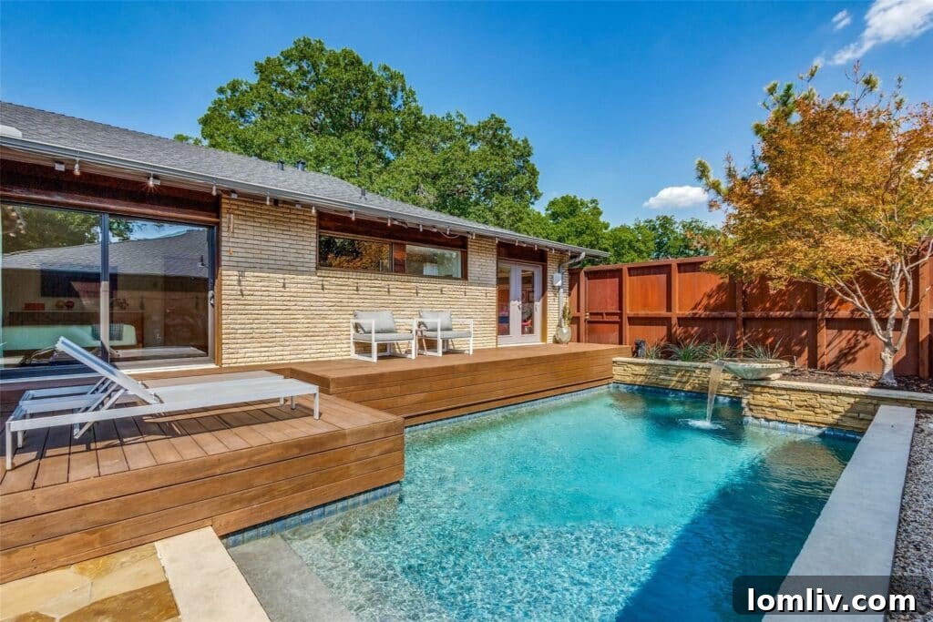Rare East Dallas Ju-Nel Gem Hits The Market Open This Weekend 7 A view of the inviting swimming pool, bordered by stacked stone and lush greenery.