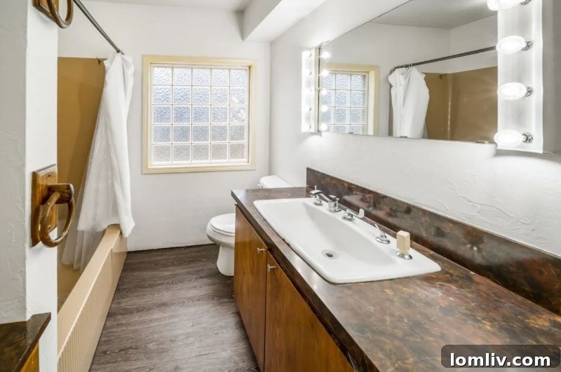 A unique bathroom sink resembling a trough, an unusual design choice within the Oklahoma City residence.