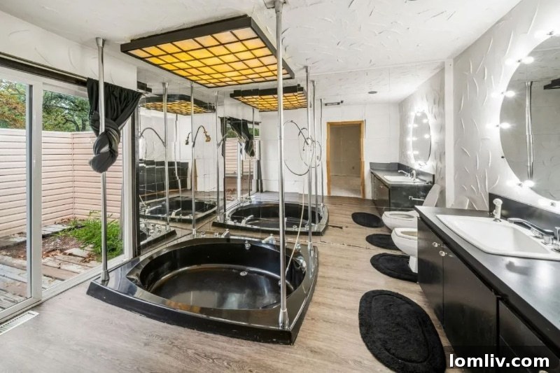 The unconventional master bathroom of the Oklahoma City house, featuring multiple chrome poles, an unexpected design element.