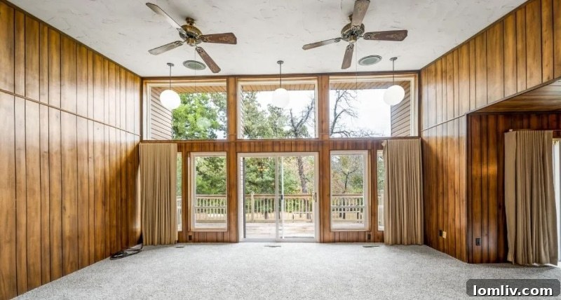 Interior living space of the 1970s Oklahoma City home, dominated by vintage brown wood paneling and classic furnishings.
