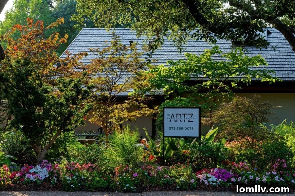 Sam Artz, founder of Artz Landscape Designs, posing confidently in a lush, meticulously designed garden setting