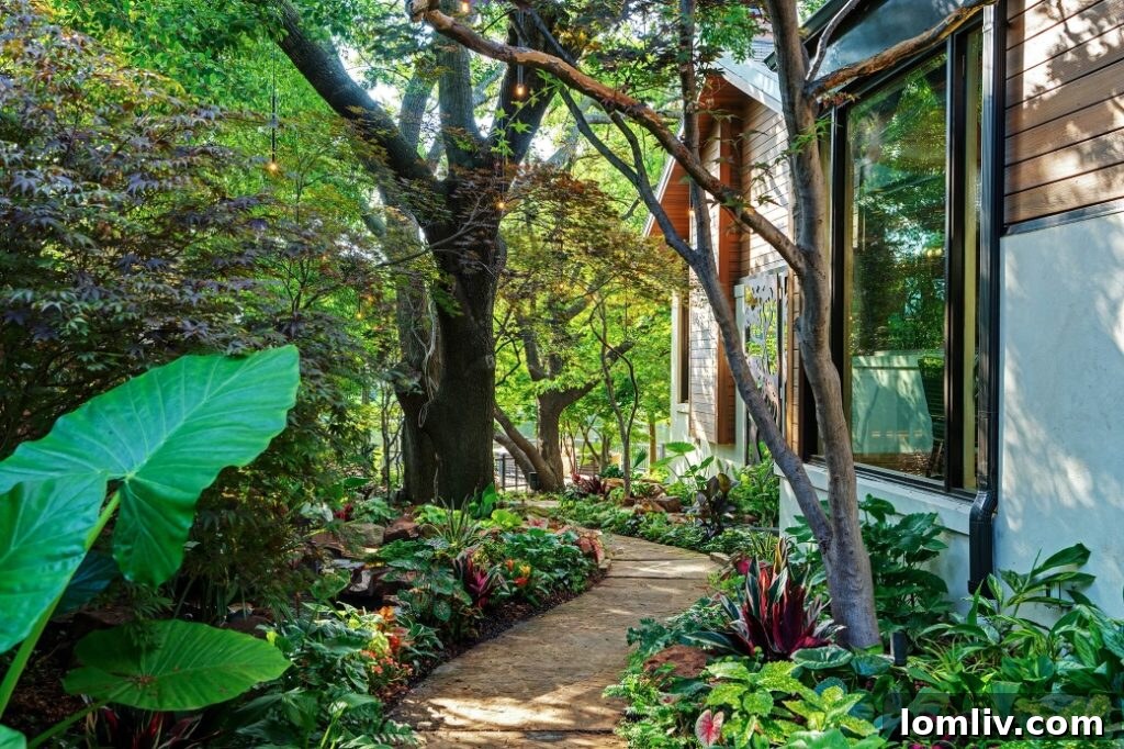 Elegant swimming pool with a natural stone patio and lush green lawn, creating a serene and inviting backyard oasis