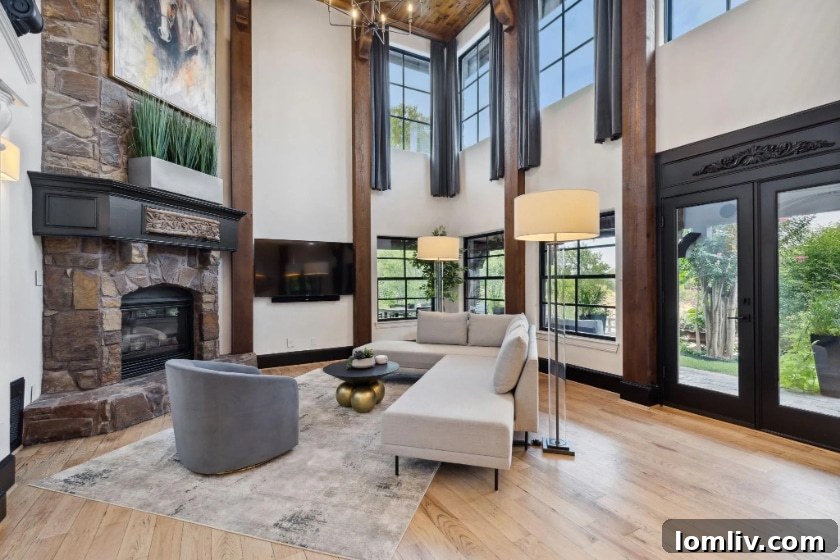 Elegant living room interior with high ceilings, fireplace, and natural light in an Argyle luxury home