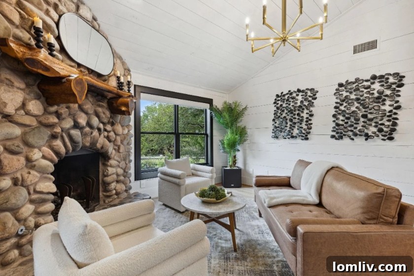 Hearth room with a comfortable sofa, elegant fireplace, and warm lighting, adjacent to the kitchen