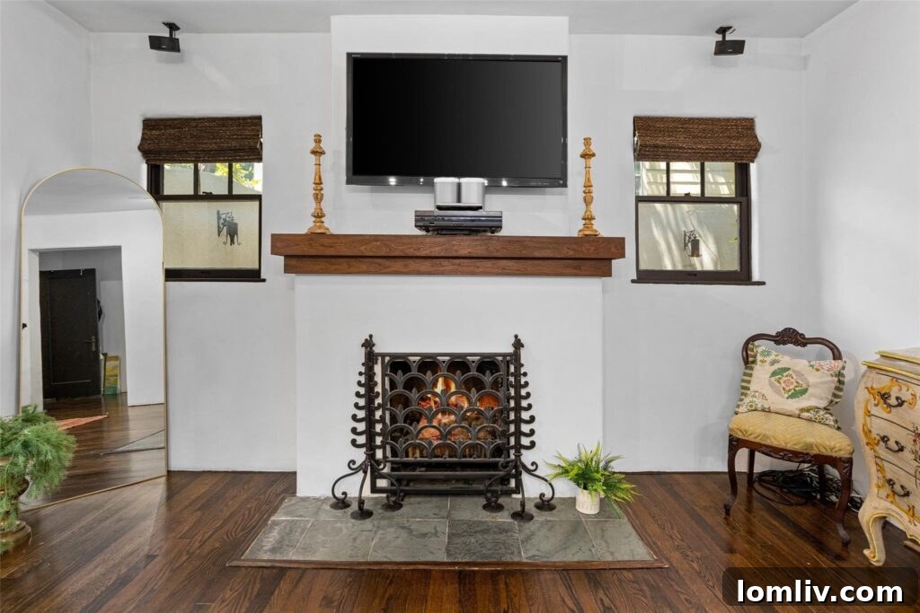 The master bedroom features a romantic fireplace and an ensuite bath with a stucco-encased tub, embodying rustic luxury.