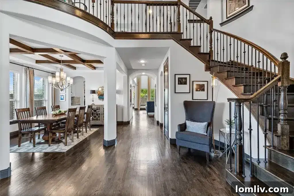 Elegant entrance hall with dark wood flooring and high ceilings in a luxury Lake Highlands home
