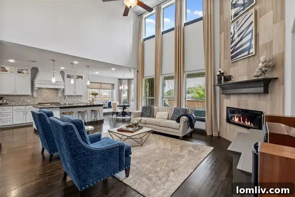 Spacious formal living room with a modern fireplace and large windows in a Dallas luxury home