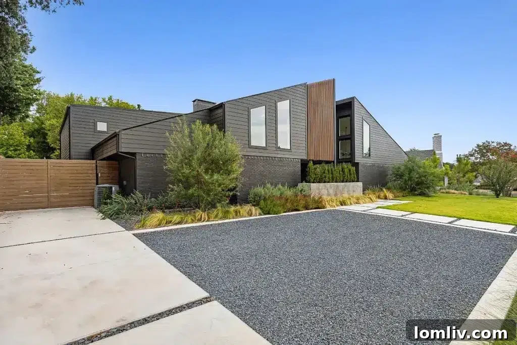 The striking facade of the Midcentury Modern home with expansive Quaker windows and natural stone.