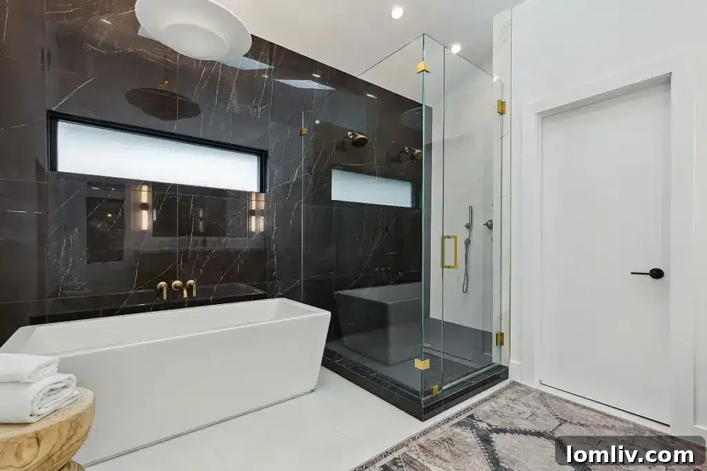 Luxurious primary bathroom with contrasting black marble and spa amenities.