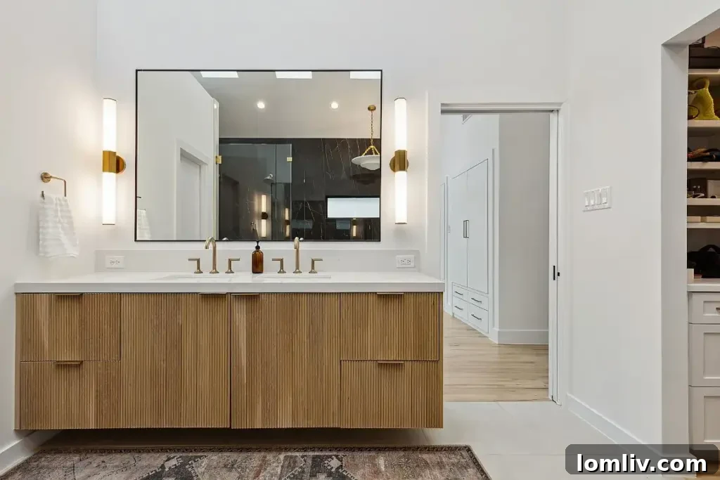 Elegant soaking tub within the spacious Midcentury Modern primary ensuite bathroom.