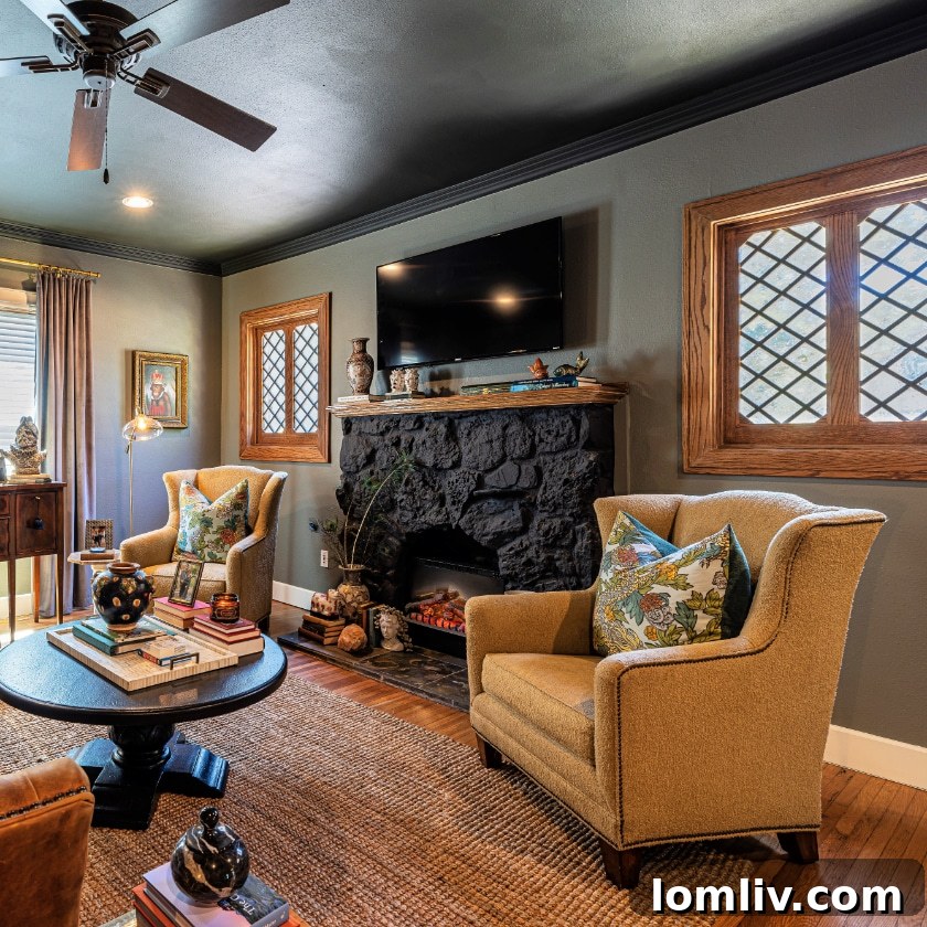 A commanding yet calming stone fireplace serving as the focal point in a historic Dallas home's elegant living space.