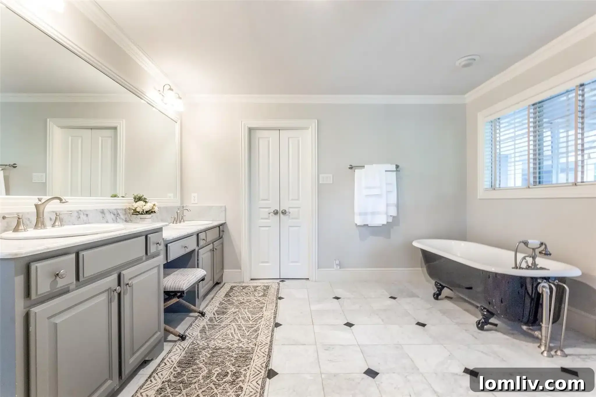 Snatch This Cape Cod-Style Home in The Peninsula Before I Do 9 Luxurious primary bathroom with dual vanities and a soaking tub.