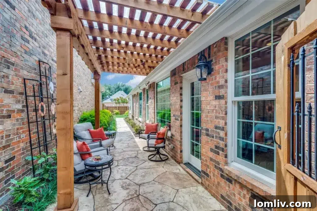 A beautifully designed private patio area with a pergola, comfortable outdoor furniture, and artificial turf, perfect for relaxation and entertaining.