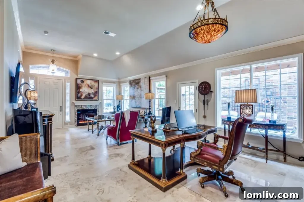 A spacious living area with a modern electric fireplace, comfortable seating, and elegant decor, featuring recessed lighting and travertine flooring.